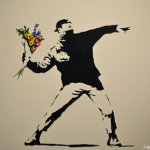 'Love is in the air (Flower Thrower)' van Banksy in het Moco Museum in Amsterdam<br/>Copyright ยฉ JTravel.nl 'Love is the air (Flower Thrower)' van Banksy in het Moco Museum in Amsterdam / Copyright ยฉ JTravel.nl